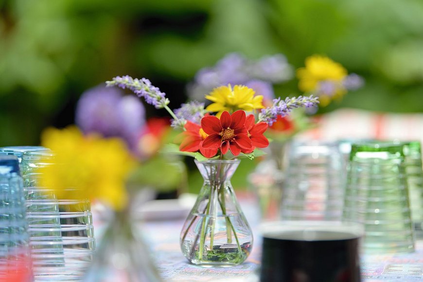 Viele Gläser stehen auf einem Tisch mit weißer Tischdecke und in der Mitte ist ein Blumenstrauß - Copyright: Foto:Lotz