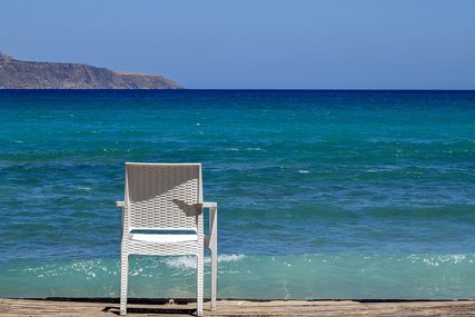 Weißer Stuhl am Strand mit Blick auf das blaue Meer - Copyright: Foto:Lotz - Gemeindebrief.de